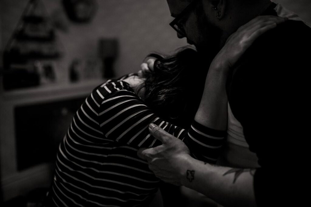 close up as parents support each other during labour.