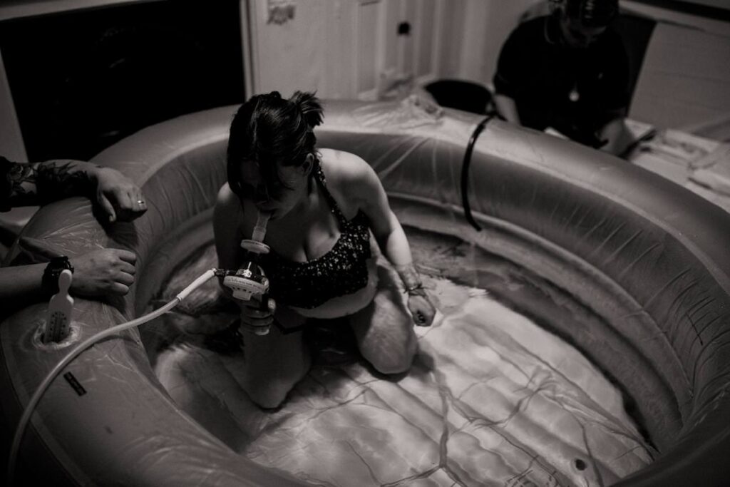 Mother labouring in a birthing pool at home