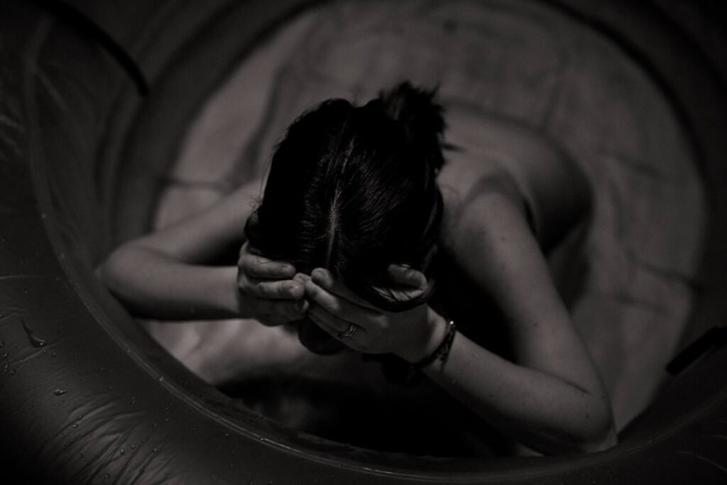 Mother labouring in a birthing pool at home
