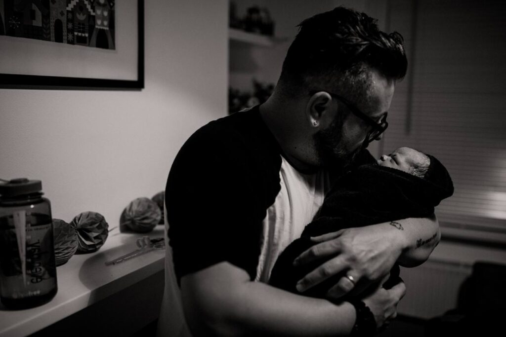 Father holding his daughter for the first time