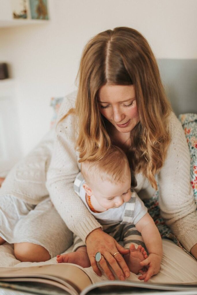 a mother reading to her baby boy