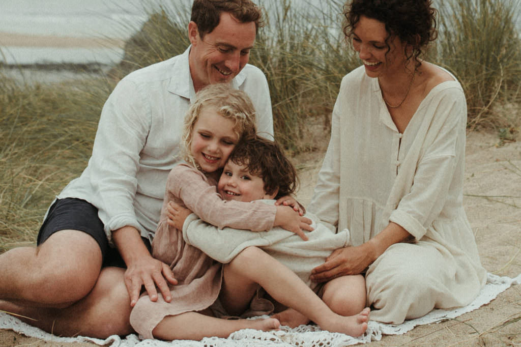 family of four children hugging during ifestyle family photography session