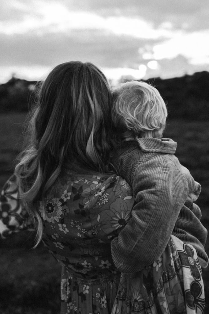 family photographer devon shoot black and white shot of the backs of the heads of mum and little boy sharing cuddle