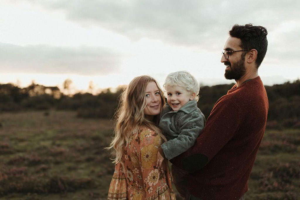 family photographer devon shoot Family shot of Dad holding little boy whilst mum leans in and both look at camera