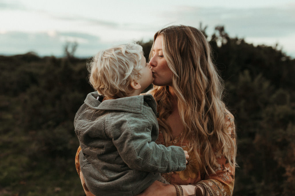 family photographer devon shoot Mum and son share a kiss as Mum holds him