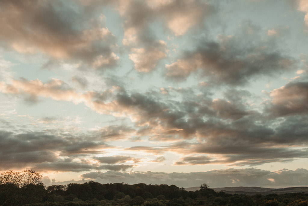family photographer devon shoot Stunning moody sunset sky with hints of pink cloud