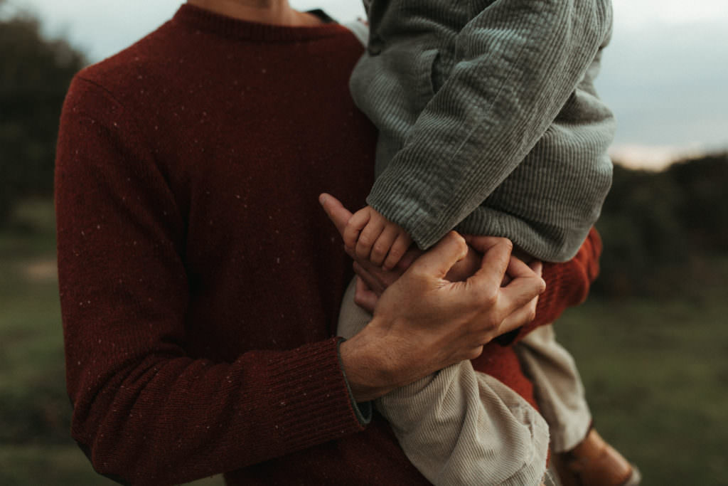 family photographer devon shoot close up of Little boy holding Dads fingers