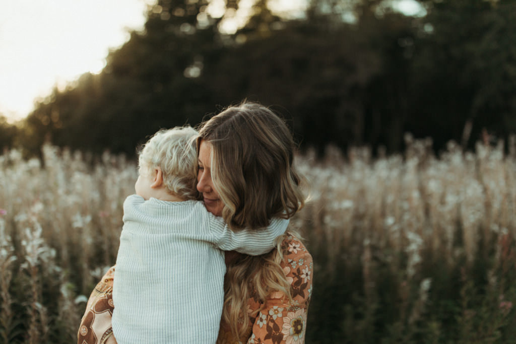 family photographer shoot Little boy snuggling into Mums arms