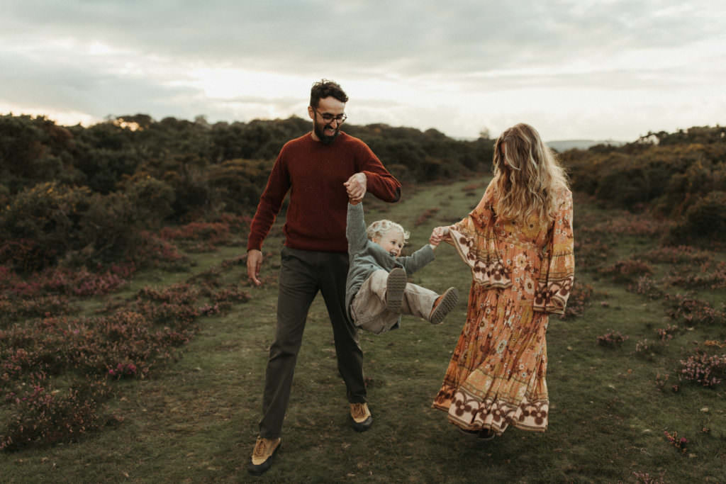 family photographer devon shoot mum and Dad swinging son