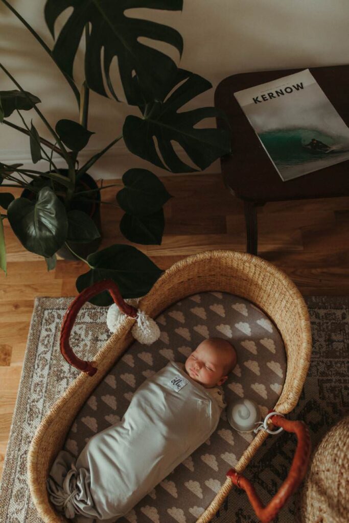 Baby laying in moses basket in their home in St Agnes Cornwall during their in-home newborn photographer session