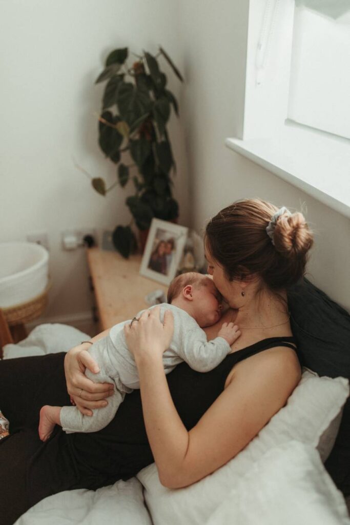 newborn baby being cuddled during calm in-home photography session