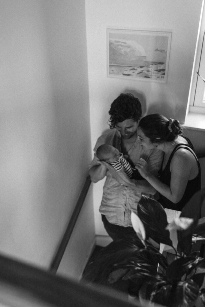 New parents cuddling their baby at home in St Agnes, Cornwall