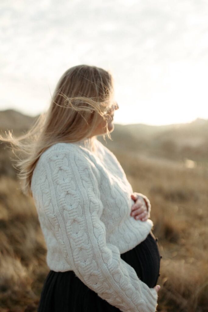intimate lifestyle maternity session outdoors with soft evening light