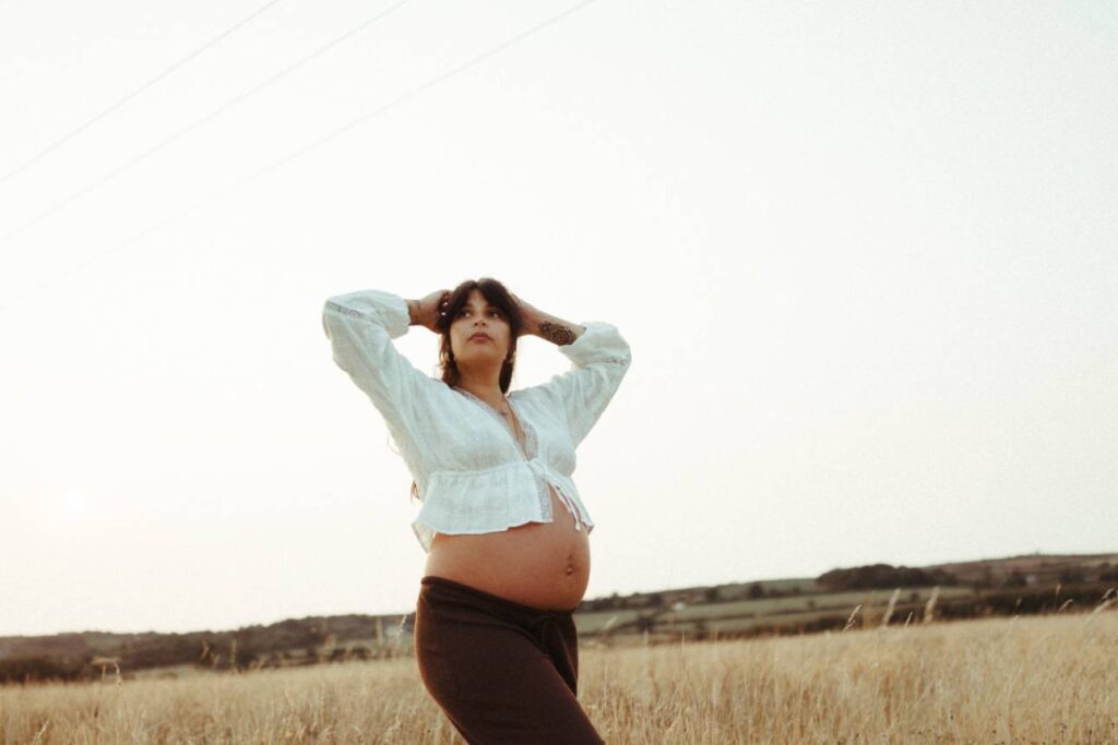 Silhouette of pregnant woman against sunset sky in Cornwall