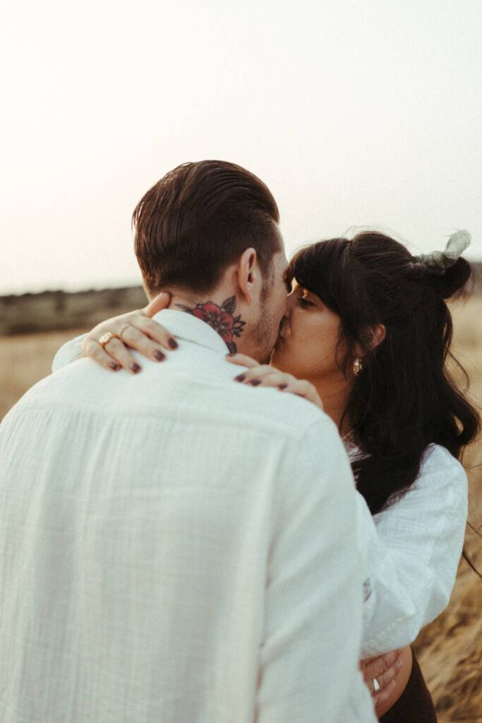 A couple kissing during their sunset maternity photoshoot