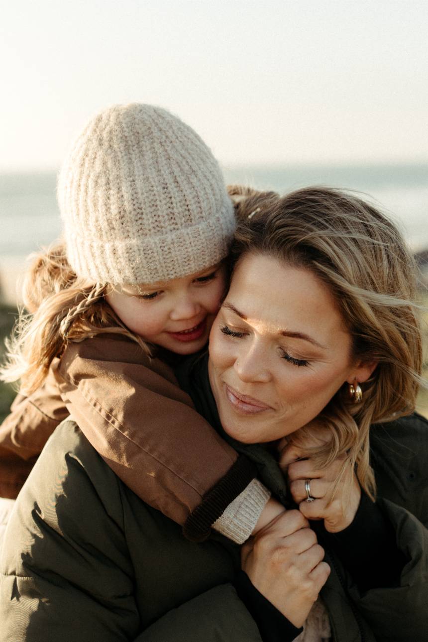 Mother and daughter hugging during a Cornwall outdoor family session with children