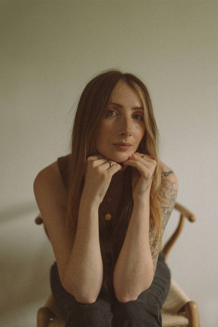 Image of Cornwall family photographer sitting on a chair and gazing into the camera.