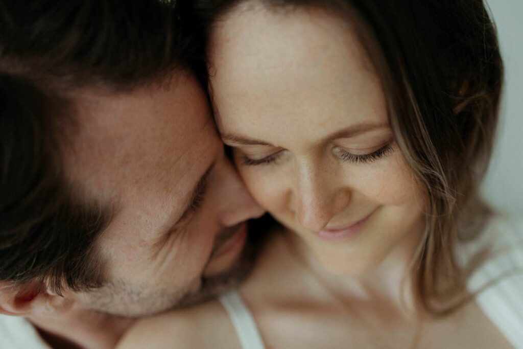 intimate moment of a couple embracing during their pregnancy photoshoot