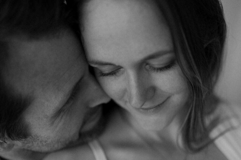 Close up of a couple embracing during maternity photoshoot in Cornwall